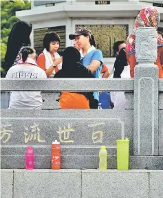  ??  ?? Seen are colourful drinking bottles belonging to athletes and volunteers lined up against a wall.