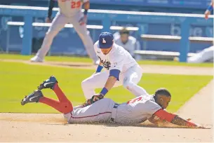  ?? MARCIO JOSE SANCHEZ/ASSOCIATED PRESS ?? The Nationals’ Victor Robles, bottom, is tagged at second base by Dodgers second baseman Gavin Lux on a steal attempt Friday in Los Angeles.