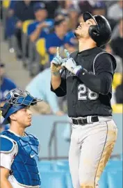  ?? Jayne Kamin-Oncea Getty Images ?? NOLAN ARENADO pauses in front of catcher Austin Barnes after his second home run of the game.