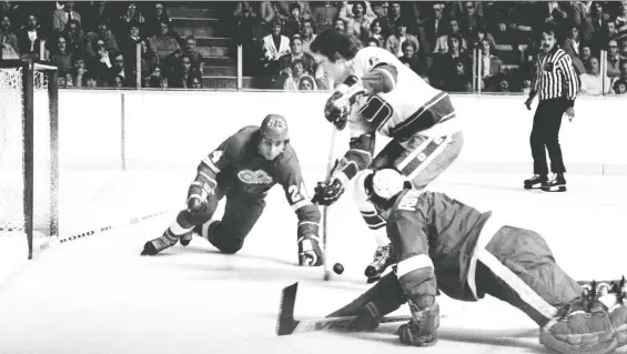  ?? PHOTO DIGITIZATI­ON PROJECT 2016 ?? The Canucks’ Rick Blight skates between two Red Wings players to score in a 1978 game. The winger averaged 26 goals over his first three seasons in Vancouver before a knee injury and a coaching change affected his play, leading to his retirement in the minors in 1983.