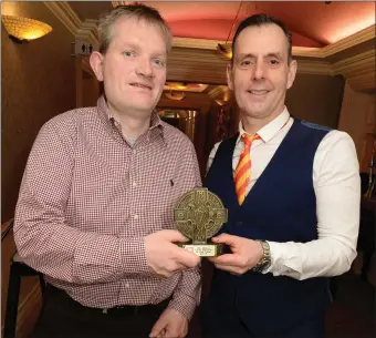  ??  ?? Jimmy Murphy receives the St. Johns GAA Club Person of the Year Award from Michael O’Riordan at their Victory Social in the Castle Hotel, Macroom. Picture John Tarrant