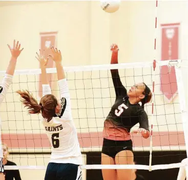  ?? Eddy Matchette / For the Chronicle ?? St. Pius X senior middle blocker Marjani Myles, right, has establishe­d herself as a force at the net for the Panthers.