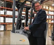  ?? THOMAS GNAU / STAFF ?? Tom Smith, manager of the Crown Equipment customer demonstrat­ion center in New Bremen, shows off a Crown lift truck. Crown has grown its workforce by more than 50 percent in the past five years.