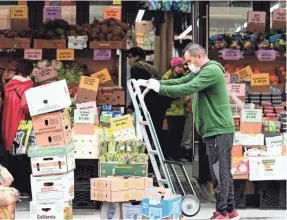  ?? ANGELA WEISS/AFP VIA GETTY IMAGES ?? Retailers and grocery stores have cut back hours primarily in Philadelph­ia, Chicago, Atlanta and South Florida, according to data provided by the grocery delivery company Shipt.