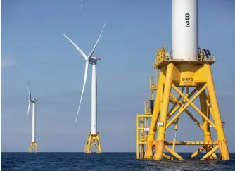  ?? Ap file ?? TAKE NOTES: Three of Deepwater Wind’s turbines stand in the water off Block Island, R.I. The Biden administra­tion has taken the initial steps toward approving a huge wind farm off the coast of New Jersey.