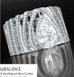  ??  ?? Bangle in white gold set with rock crystal and diamonds by Cartier