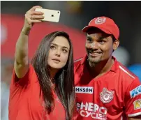  ?? AFP file ?? Kings XI Punjab’s owner Preity Zinta takes a selfie with Sandeep Sharma. —