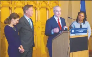  ?? Emilie Munson / Hearst Connecticu­t Media ?? Ryan Drajewicz, at the podium, and Melissa McCaw, at right, were named chief of staff and secretary of the Office of Management and Budget, respective­ly, by Gov.-elect Ned Lamont. At left are Lamont and Lieutenant Gov.-elect Susan Bysiewicz.