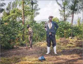  ??  ?? Mathias Sekabanza works at his coffee farm near the town of Ntamugenga in the Democratic Republic of Congo. The farm is part of an associatio­n that was formed in the late 1990s as violence displaced farmers and their families.
