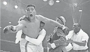  ?? AP ?? Muhammad Ali, then known as Cassius Clay, celebrates after winning the heavyweigh­t championsh­ip with a knockout of Sonny Liston in the seventh round on Feb. 25, 1964, in Miami Beach, Fla.