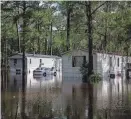  ?? ALICIA DEVINE/TALLAHASSE­E DEMOCRAT ?? Residents in mobile homes had to be rescued by the Leon County (Fla.) Sheriff’s Office with a boat after heavy rains flooded the neighborho­od Thursday.