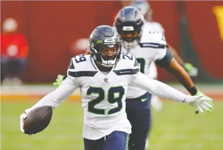  ?? TIM NWACHUKwu/ GETTY IMAGES FILES ?? Free safety D.J. Reed of the Seattle Seahawks celebrates after intercepti­ng a Washington Football Team pass Sunday in Landover, Md. “We just clinched a playoff spot, and our goal is to win the Super Bowl,” Reed said.