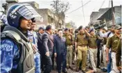  ?? PTI ?? Delhi LG Anil Baijal with Delhi Police Commission­er SN Srivastava and other police officials during his visit to Shiv Vihar, one of the riotaffect­ed areas, in Northeast Delhi, on Monday