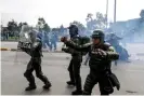  ??  ?? Riot police in Bogotá on Thursday. Photograph: Juan Barreto/AFP via Getty Images