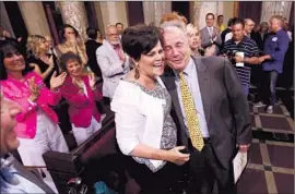  ?? Genaro Molina
Los Angeles Times ?? TOM LABONGE hugs his wife, Brigid, at a celebratio­n of his 40- year career in city government June 23 at City Hall, where colleagues praised him as “Mr. L. A.”