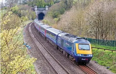  ?? GLEN BATTEN. ?? Great Western Railway 43021 exits Twerton Tunnel (west of Bath) on April 4, leading GWR’ s 1130 Paddington to Bristol Temple Meads service. There have been delays to electrific­ation on the Great Western Main Line, along which the diesel HSTs have...