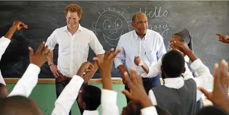  ?? PHOTOS: AP ?? Prince Harry, with Prince Seeiso of Lesetho, during his visit to the Kananelo Centre for the Deaf outside Maseru, Lesotho in 2013.