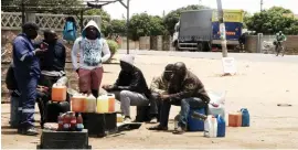  ??  ?? Service stations are now synonymous with long queues of motorists looking for fuel. The picture taken in Cowdray Park suburb, Bulawayo, shows illegal fuel dealers displaying the now elusive precious liquid in all forms of containers which they sell at double the official price. — (Picture by Nkosizile Ndlovu)