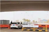  ?? AMY QIN/THE NEW YORK TIMES ?? A checkpoint to screen vehicles heading Monday to the new Huoshensha­n Hospital in Wuhan, China. People desperate for treatment started descending on the new hospital.