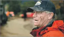  ??  ?? A MUDDY Mark Olson stands along Olive Mill Road after trying to save his house, which suffered minor damage in the storm.