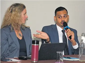  ?? Pictures: BALJEET SINGH ?? Right: USGS Supervisor­y Research Biologist Dr Robert Fisher speaks at the traffickin­g of wildlife conference.
Left: Jenna Dawson-Faber (left) looks on as PS for Environmen­t and Climate Change Dr Sivendra Michael speaks.