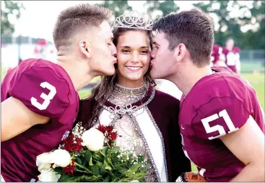  ?? Westside Eagle Observer/RANDY MOLL ?? Homecoming captains Peyton Wright and Garrett Hays kiss queen Danielle Spencer on the cheek at homecoming ceremonies at Gentry High School on Friday, Oct. 5.