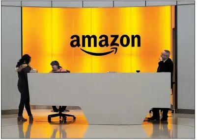  ?? AP ?? People stand in the lobby of Amazon offices in New York in February. Amazon’s investment in its own brands has prompted fear among merchants that it would lure their customers away, but a report from Marketplac­e Pulse says most Amazon-owned brands aren’t resonating with shoppers.