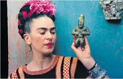  ??  ?? TROUBLED GENUIS: Kahlo with an Olmec, an early Mexican civilisati­on