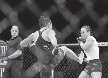  ?? Douglas P. Defelice, Getty Images ?? Carla Esparza kicks Aurora native Michelle Waterson during their UFC 249 strawweigh­t fight at Veterans Memorial Arena in Jacksonvil­le, Fla., on Saturday. Esparza defeated Waterson.