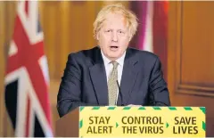  ?? AFP ?? British Prime Minister Boris Johnson speaks during a remote press conference inside 10 Downing Street in London on Sunday.