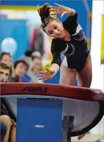  ?? SEAN D. ELLIOT/THE DAY ?? Old Lyme’s Maria Denya launches herself onto the vault during the Shoreline Conference gymnastics championsh­ips on Friday at ABC Shoreline Gymnastics in East Lyme. Denya finished second in the allaround competitio­n and helped the Wildcats win the team title.
