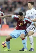  ??  ?? WALES: Burnley’s Andre Gray, left, and Swansea City’s Federico Fernandez battle for the ball during their English Premier League soccer match at the Liberty Stadium, Swansea, Wales, yesterday. — AP