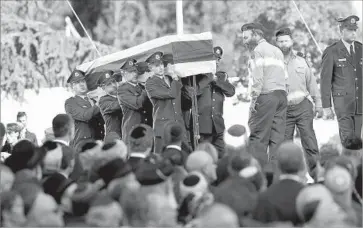  ?? Ariel Schalit Associated Press ?? AN HONOR GUARD carries the flag-draped coffin of former Israeli President Shimon Peres in Jerusalem. In a eulogy, President Obama gently urged Israelis to pursue Peres’ goal of reconcilia­tion with the Palestinia­ns.
