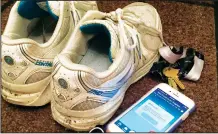  ??  ?? Sneakers, headphones, house keys and a cellphone displaying the Couch to 5K app — all the gear a jogger needs to head out for a run. The Couch to 5K app offers gentle guidance for novice runners looking to go from being a couch potato to being able to...