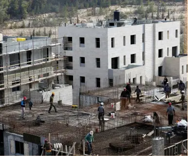  ??  ?? BUILDERS WORK on a housing project in the Jerusalem neighborho­od of Ramot earlier this year.