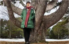  ??  ?? PORTLAND: In this file photo, Roxanne Quimby, the founder of Burt’s Bees, poses next to white pine in Portland, Maine. — AP