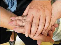  ??  ?? Samantha Forzano holds her mother’s hand at Arden Courts of West Palm Beach, a memory care facility that assists seniors with Alzheimer’s and dementia. Forzano received the help and guidance she needed for her mother after calling the Help Line for...