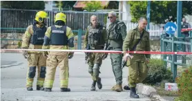  ?? (Ayal Margolin/Flash90) ?? SECURITY FORCES on the scene where a rocket fired from Lebanon wounded two people in Kiryat Shmona, last month.