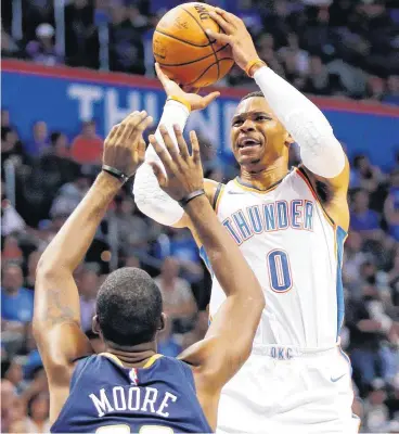  ??  ?? Oklahoma City’s Russell Westbrook shoots as New Orleans’ E’Twaun Moore defends in Friday’s preseason NBA basketball game between the Oklahoma City Thunder and the New Orleans Pelicans at Chesapeake Energy Arena. The Thunder won, 102-91.