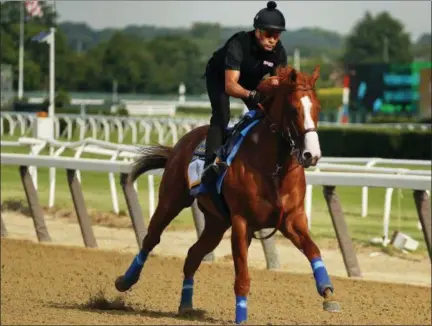  ?? JULIE JACOBSON — THE ASSOCIATED PRESS ?? Triple Crown hopeful Justify gallops around the main track during a workout at Belmont Park, Friday in Elmont, N.Y. Justify will attempt to become the 13th Triple Crown winner when he races in the 150th running of the Belmont Stakes horse race today.