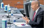  ?? POOL / GETTY IMAGES ?? Sen. Cory Booker speaks as Judge Amy Coney Barrett appears before the Senate Judiciary Committee on day two of her confirmati­on hearings.