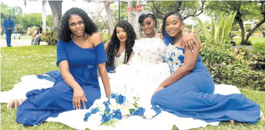  ??  ?? Kadion Smith (centre), takes a moment with her bridal party. From left: Doniel Edwards, the maid of honour, and bridesmaid­s Roshelle Tracey, and Tavian Stephenson.