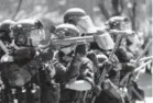  ?? Photos by Mark Graves, The Oregonian ?? Police prepare to push back against protesters as scuffles break out.