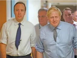  ?? AP/POOL/CHRISTOPHE­R FURLONG ?? Britain’s Prime Minister Boris Johnson, right, and Health Minister Matt Hancock, pictured in November 2019, have both tested positive for the new coronaviru­s