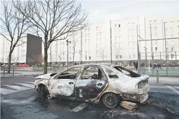 ??  ?? Photo shows the wreckage of a burnt car in one of the main streets of the Rose des Vents district also known as the Cite des 3000 (City of 3000) in Aulnay-sous-Bois. — AFP photo