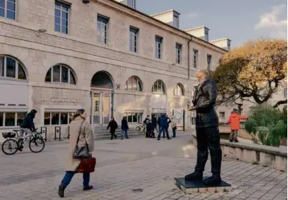  ?? PHOTOS BY ANDREA MANTOVANI/NEW YORK TIMES/FILE ?? A passerby glanced at a statue of author Victor Hugo, created by Senegalese sculptor Ousmane Sow, in Besançon, France, last month. After a restoratio­n darkened its features, the statue was defaced.