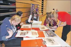  ??  ?? 01_B17memory0­1 Pupils study the old school photograph­s which were on display.