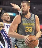  ?? COMMERCIAL APPEAL ?? Grizzlies center Marc Gasol pounds the ball inside against 76ers guard Ben Simmons during their game Saturday at FedExForum. JOE RONDONE/THE