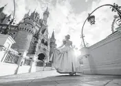  ?? MATT STROSHANE/WALT DISNEY WORLD Handout ?? Cinderella poses in front of Cinderella Castle inside Magic Kingdom Park