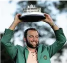  ?? Reuters ?? On top of the world: Scottie Scheffler celebrates with his Green Jacket and the trophy after winning The Masters. /